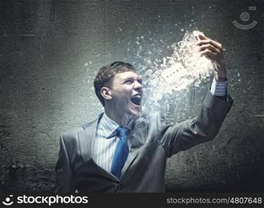 Aggressive business. Angry businessman screaming i to mobile furiously phone
