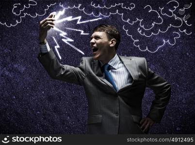 Aggressive management. Angry businessman screaming furiously in mobile phone