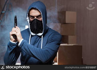 Aggressive manwith gun wearing face mask