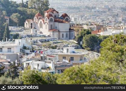 Agia Marina or Saint Marina orthodox church situated on the Hill of the Nymphs in Athens, Greece. The city of Athens can be seen in the background.