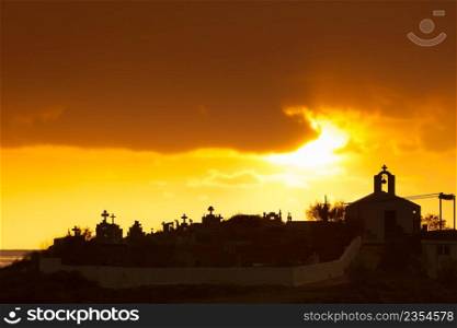 Agios Fokas near Monemvasia in stormy weather overcast sky, sunrise. Small cemetery on sea shore, Maleas peninsula region Peloponnese. Agios Fokas Greece, sunrise at stormy weather