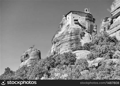Agios Nikolaos monastery on the top of cliff in Meteora, Greece - Black and white landscape