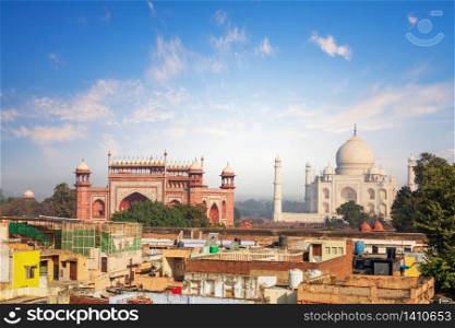 Agra view: poor houses and Taj Mahal, India.