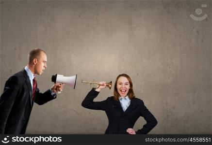 Agressive management. Businessman using megaphone to scream agressively at woman