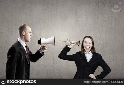 Agressive management. Businessman using megaphone to scream agressively at woman