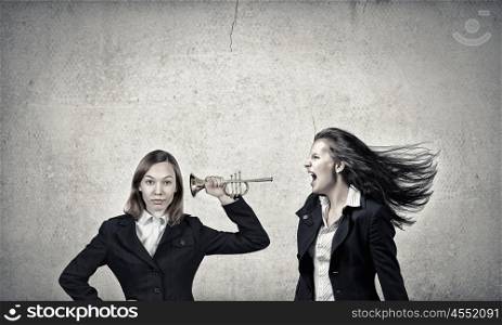 Agressive management. Businesswoman scream agressively in horn at another woman