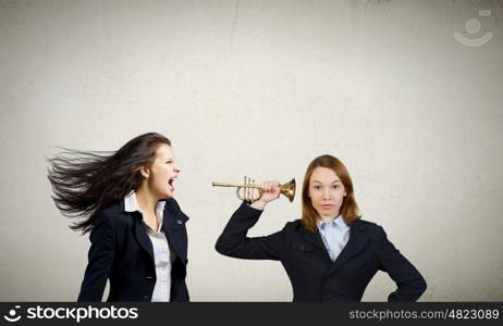 Agressive management. Businesswoman scream agressively in horn at another woman