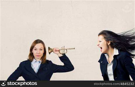 Agressive management. Businesswoman scream agressively in horn at another woman