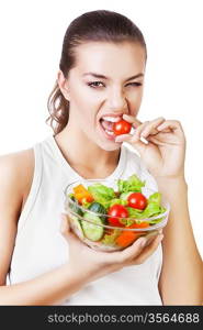 agressive woman biting tomato on white background