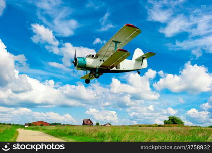 agricultural aircraft flying low over a field