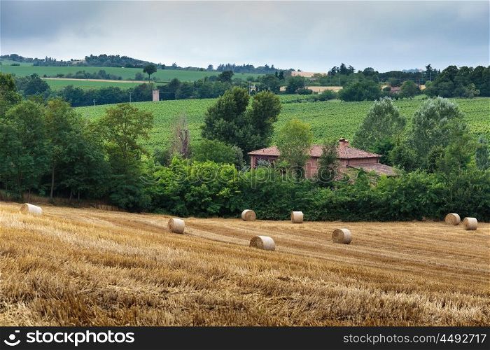 Agricultural field with straw bales after harvest in Italy
