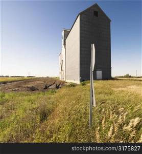 Agricultural grain elevator in rural field.