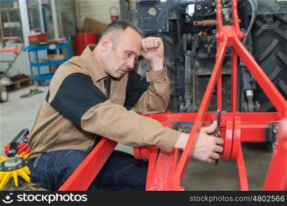 Agricultural mechanic looking stressed