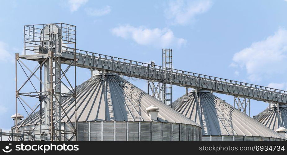 Agricultural storage tanks. Silos for storing cereals. Countryside scene.