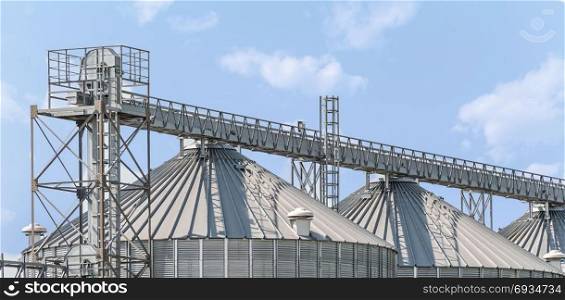 Agricultural storage tanks. Silos for storing cereals. Countryside scene.