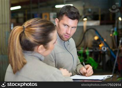 agricultural technician and mechanic having conversation