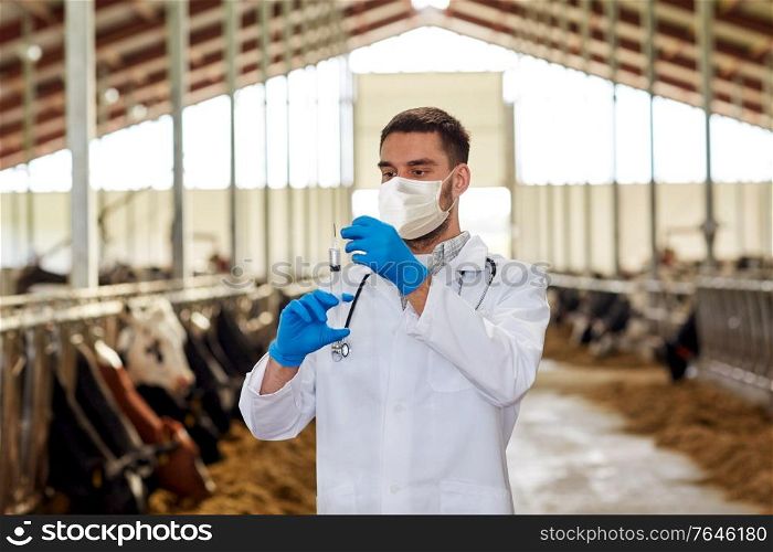 agriculture industry, farming, medicine and animal husbandry concept - veterinarian or doctor with syringe wearing medical mask vaccinating cows in cowshed on dairy farm. veterinarian in mask with syringe and cows on farm