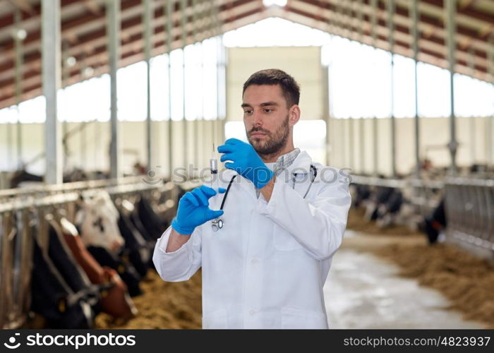 agriculture industry, farming, medicine, animal vaccination and people concept - veterinarian or doctor with syringe vaccinating cows in cowshed on dairy farm