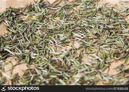agriculture, manufacture, industry and farming concept - close up of tea raw drying