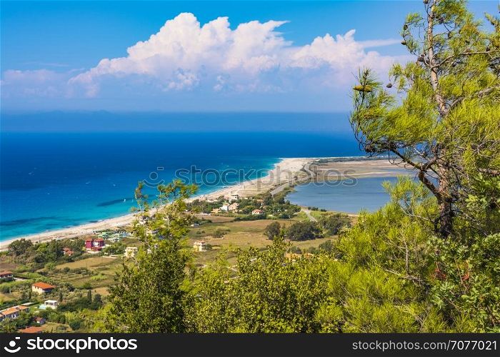Ai Yiannis, Mili is a long sandy beach on the island of Lefkada, Greece. Preferred by wind and kite surfers. It covers a stretch of 4.5 km and the waters are turquoise coloured.