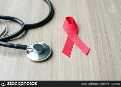 Aids Day and Heart disease Cancer Awareness, Red Ribbon with stethoscope for supporting people living and illness. Healthcare concept