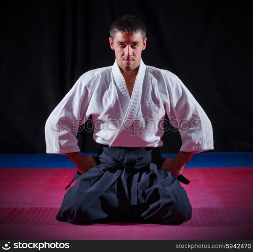 Aikido fighter on black background