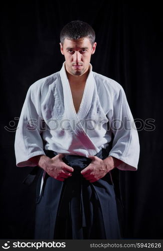 Aikido fighter on black background