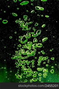 Air bubbles green on a black background