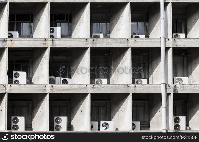 Air compressor outside high building. Hot weather in summer. Air condition. Abstract architecture pattern with sunlight and shadow.