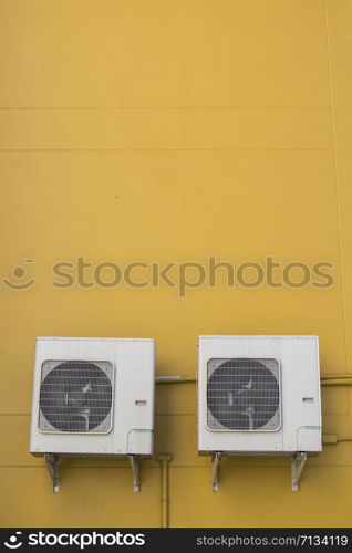 Air conditioning compressor on the yellow wall background