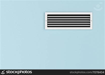 Air conditioning vent on the blue wall