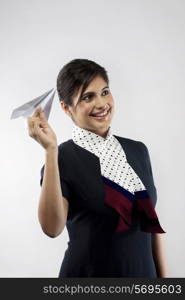 Air hostess holding a paper plane
