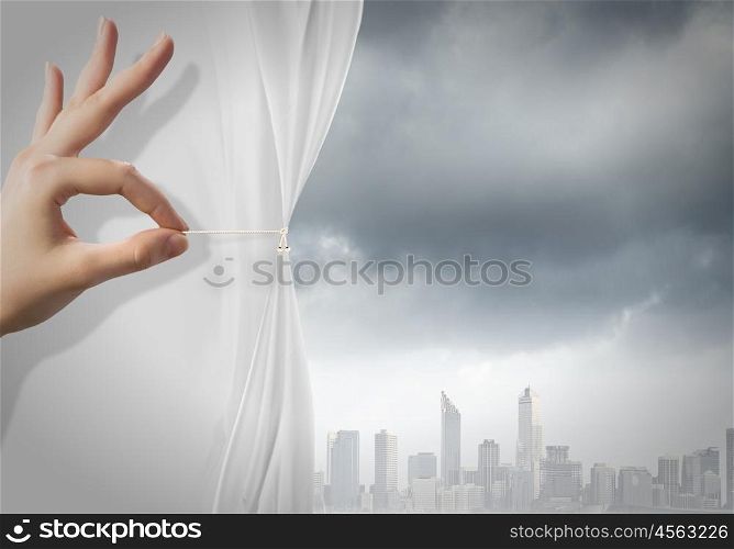 Air pollution. Close up of hand opening the white curtain