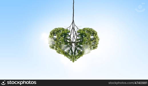 Air pollution. Conceptual image of green tree shaped like heart