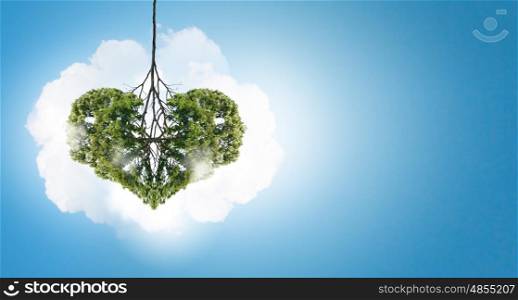 Air pollution. Conceptual image of green tree shaped like heart