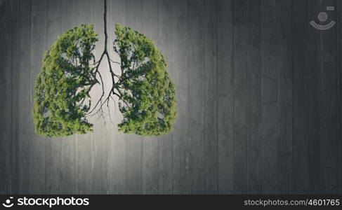 Air pollution. Conceptual image of green tree shaped like human lungs