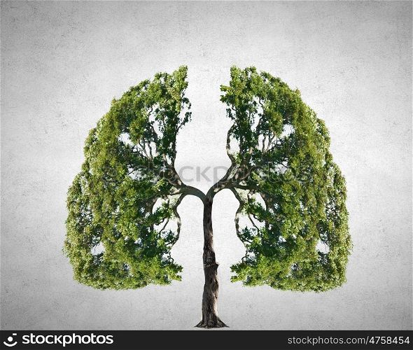 Air pollution. Conceptual image of green tree shaped like human lungs