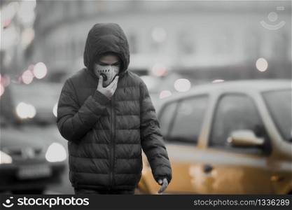 Air Pollution in a City, Boy Wearing Breathing Mask, Heavy Traffic in the Background; Carbon Emission Concept. Air Pollution in a City, Heavy Traffic, Carbon Emission Concept
