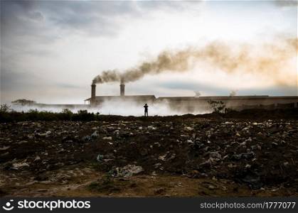 Air pollution with black smoke from chimneys and industrial waste.. industrial waste.