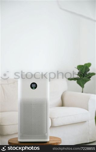 air purifier a living room, air cleaner removing fine dust in house. protect PM 2.5 dust and air pollution concept