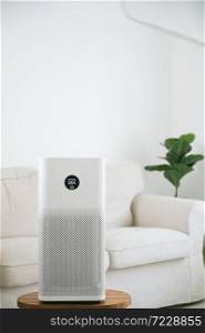 air purifier a living room, air cleaner removing fine dust in house. protect PM 2.5 dust and air pollution concept