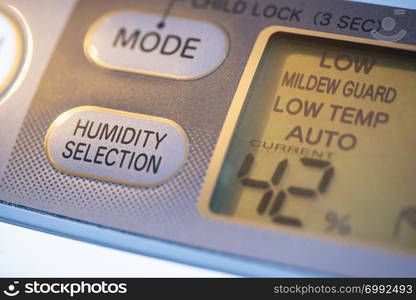 Air Purifier and dehumidifier. Concept for dehumidifying room. Humidity selection button. Humidity percentage display. Close-up device.