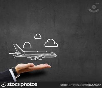 Air transportation. Close up of businessman hand holding drawn airplane