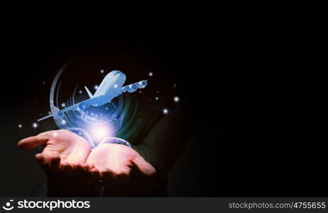 Aircraft concept. Close up of businessman hand holding airplane in palm