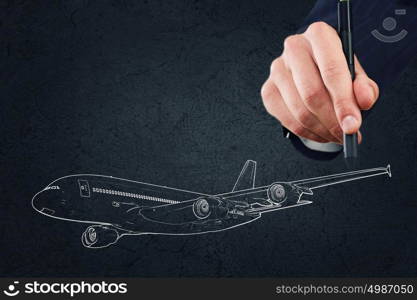 Aircraft concept. Close up of hand drawing airplane on black background