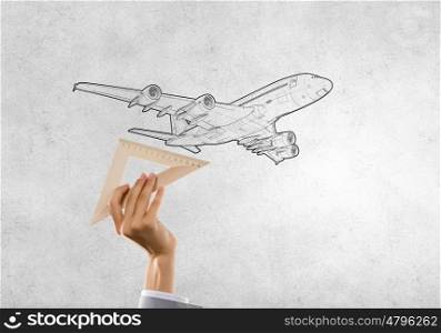 Aircraft concept. Close up of people hands measuring airplane wih ruler
