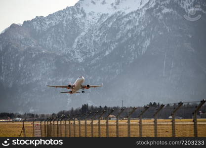 Aircraft is taking off, idyllic mountain range in the background