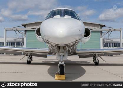 Aircraft learjet Plane in front of the Airport with cloudy sky. Aircraft learjet Plane in front of the Airport with cloudy sky and sun