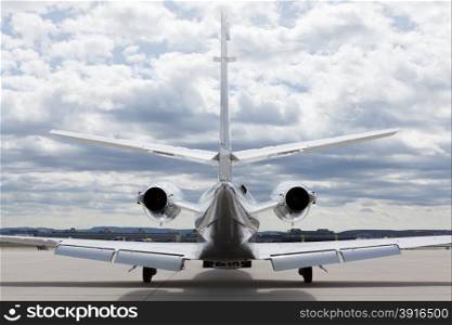 Aircraft learjet Plane in front of the Airport with cloudy sky. Aircraft learjet Plane in front of the Airport with cloudy sky and sun