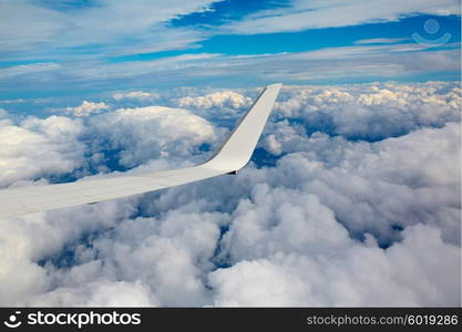 Aircraft wing in a cloudy stormy clouds sky flying